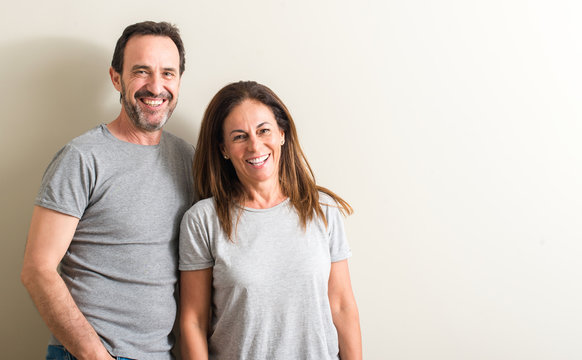 Middle Age Couple, Woman And Man With A Happy Face Standing And Smiling With A Confident Smile Showing Teeth