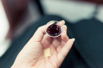 Woman hand holding wine cup and bread piece | Christian ritual to commemorate of Jesus