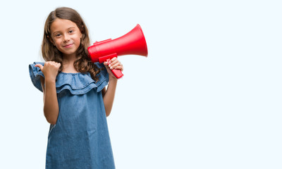 Brunette hispanic girl holding red megaphone pointing and showing with thumb up to the side with happy face smiling