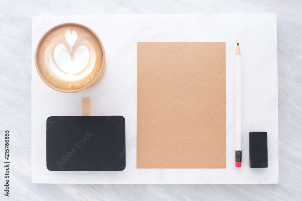 Poster Top view of Clip blackboard, pencil, eraser notepad and coffee cup on white marble block and stack on grey marble table.Flat lay Mock up template for adding or display text or design.Stationery item.