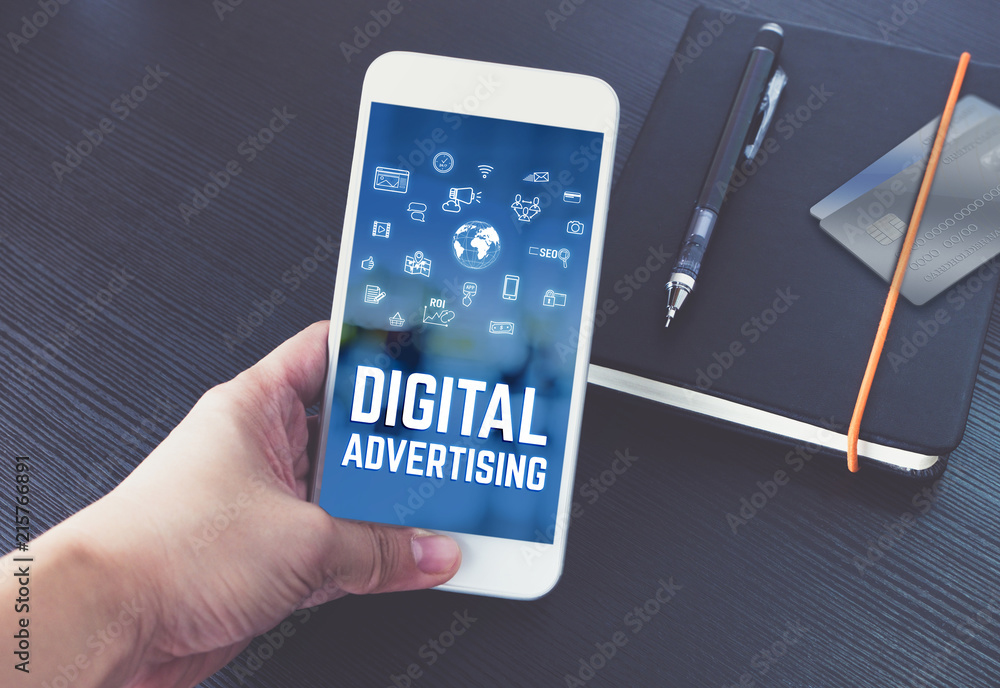 Poster hand holding mobile talking with digital advertising on screen with black notebook and credit card o