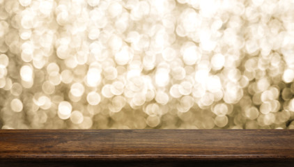 Empty old rustic dark wood table top with blur sparkling gold bokeh abstract background,panoramic banner for display or montage of product,Holiday seasonal concept backdrop.