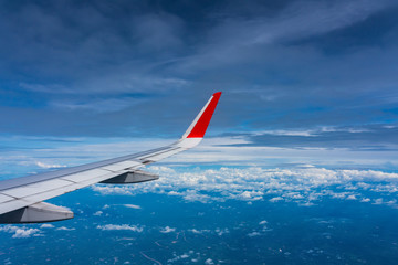 Fototapeta na wymiar Wing of an airplane sky high cloud view 