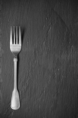 Metallic silverware on slate
