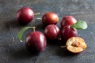 Fresh plums on stone