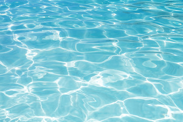 Fototapeta na wymiar Blue swimming pool rippled water background