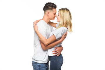 affectionate couple embracing and going to kiss isolated on white