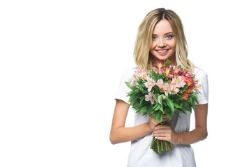 smiling attractive girl in white shirt holding bouquet of flowers isolated on white