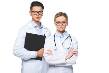 serious doctors standing with stethoscope and clipboard isolated on white