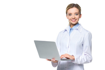 young smiling doctor in white coat holding laptop, isolated on white