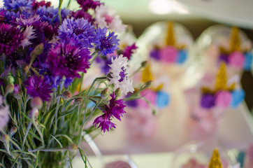 Candy bar on a child's birthday. Decor with unicorns on the girl's holiday. Flowers on the front