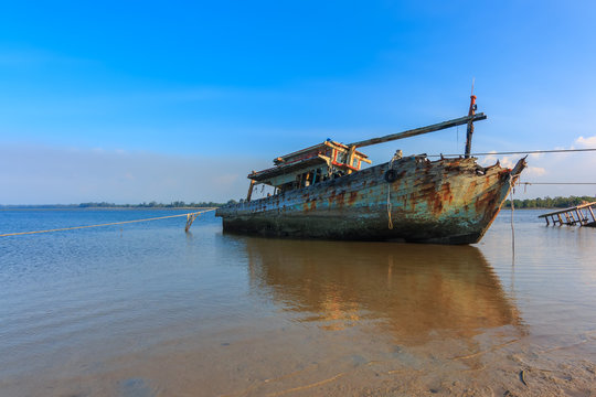 Broken and old fishing boat , Three Ship Wreck in Kuala Penyu, Sabah, Malaysia , Abandoned Ship at sabah borneo malaysia Image has grain or blurry or noise and soft focus when view at full resolution.