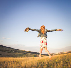 Girl jumping on summer meadow background
