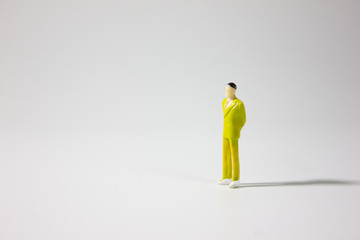 One miniature businessman on gray background.