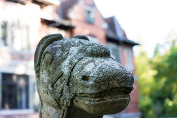 animal stone sculpture in park close up head view