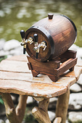 Wooden beer keg with a two tap on table