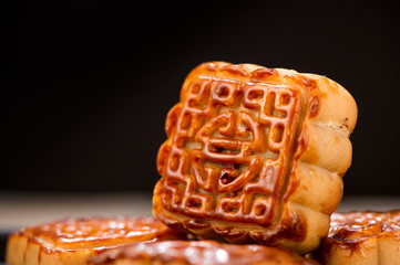 Mooncake in chinese traditional mid-autumn festival(moon festival) with copy space(text space) and table setting, close up.