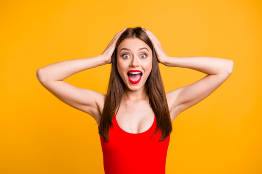 Close up portrait of  girl with a shocked face holds her head in her hands and can not believe in discounts on travel and journey to the sea isolated on vivid yellow background