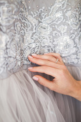 Details of a gray fashionable silk wedding dress embroidered with lace, beads and bugles