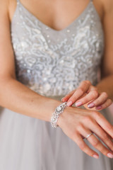 Bride's hands wearing bracelet with jewelry stones