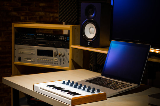 music keyboard and professional recording equipment in sound studio