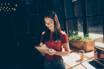 Attractive nice smiling young girl freelancer student wearing casual in cafeteria, working remotely...