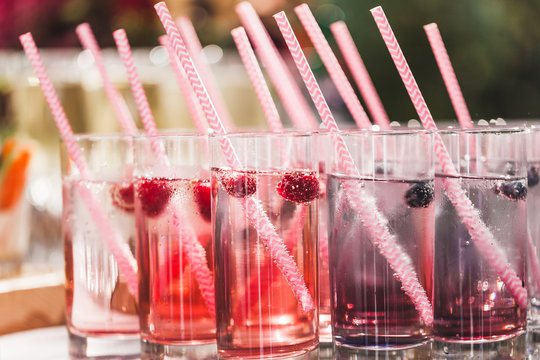 Various cold fresh drinks, berries lemonade closeup on wedding reception