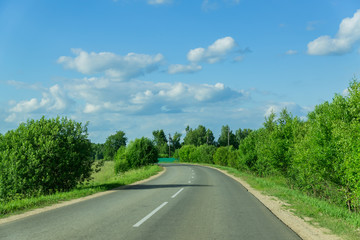 empty car road through the forest in summer day in Russia