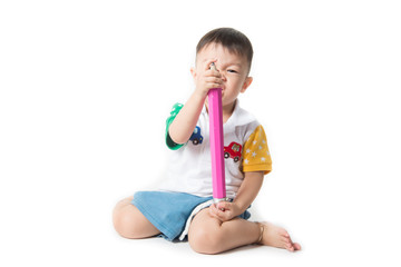 Baby toddler boy with big pencil in hand on white background