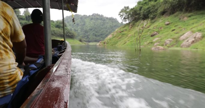 Boat ride at Khun Dan Prakan Chon dam at Nakhon Nayok province in thailand. The park is the largest area of virgin forest in middle Thailand and is a remnant of rain forest which is older.
