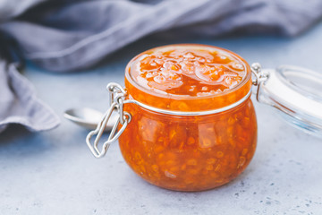 Glass jar with cloudberry jam. Nordic cuisine.