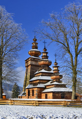 Beautiful ancient greek catholic wooden church in village of Kwiaton in winter, inscribed on the UNESCO World Heritage list, Low Beskid (Beskid Niski), Poland
