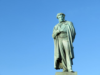 Monument to famous russian writer and poet Alexander Pushkin in Moscow, isolated on clear blue sky...