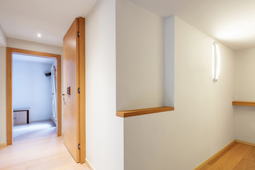 Fully white corridor with parquet in modern apartment