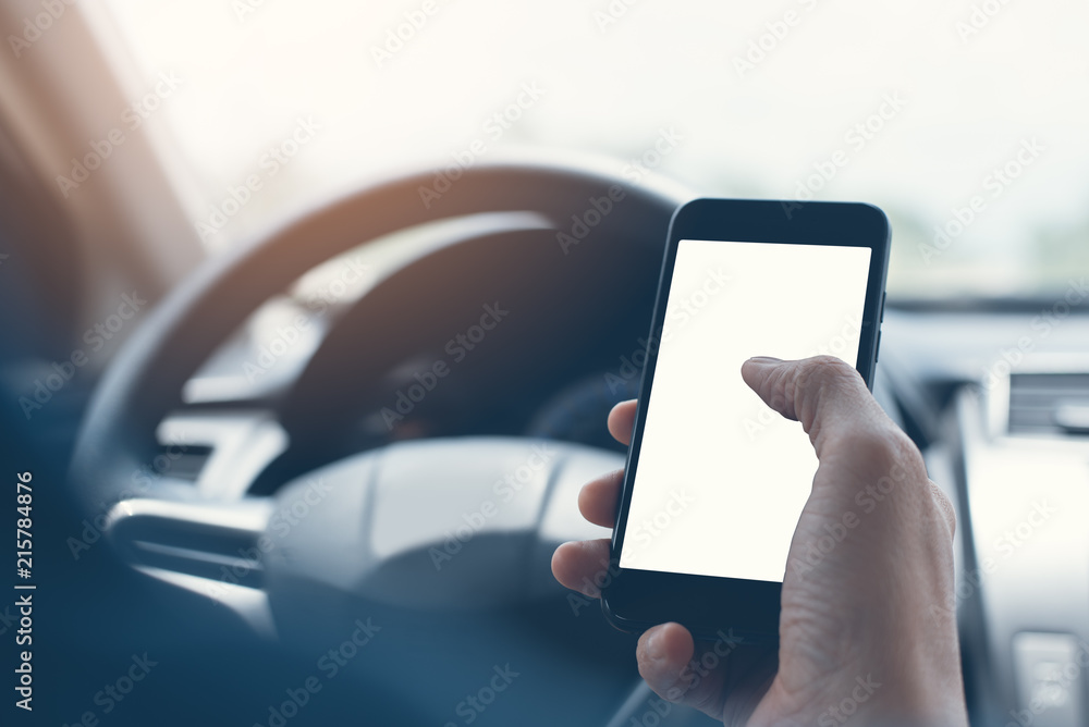 Poster man using smartphone inside a car