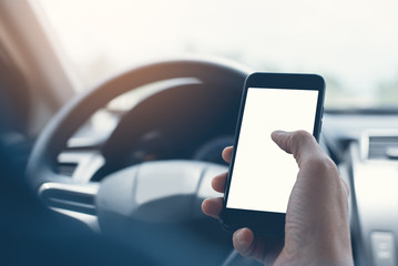 Man using smartphone inside a car