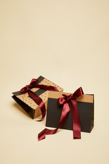 fashionable shopping bags with bows isolated on beige