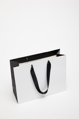 one open black and white shopping bag isolated on white