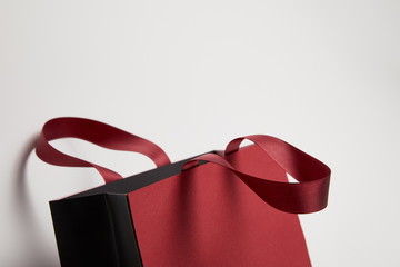 one new burgundy shopping bag on white