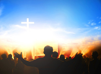 Church worship concept:Christians raising their hands in praise and worship at a night music concert