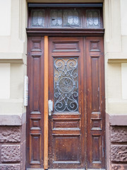 Vintage wooden door with decorative metal bar on window. Heidelberg, Germany.
