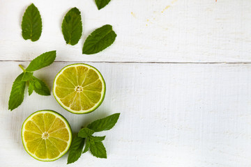 Lime and mint on a white  table.