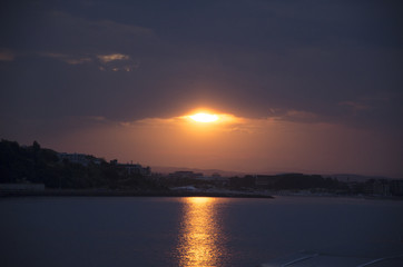Fototapeta na wymiar Amazing sunset in the city near the sea