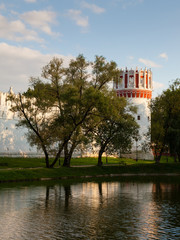 The walls and towers of the Novodevichy monastery in Moscow are reflected in the water in the...