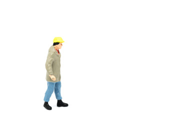 Miniature people engineer worker construction on white background with a space for text