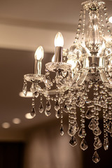 Chrystal chandelier lamp on the ceiling in Dining room Adjusting the image in a Luxury tone...
