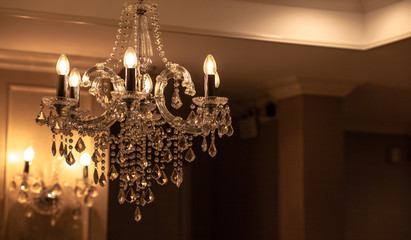 Chrystal chandelier lamp on the ceiling in Dining room Adjusting the image in a Luxury tone...