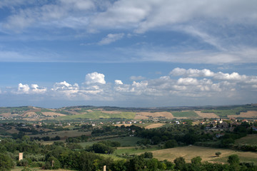 Fototapeta na wymiar landscape,countryside,horizon,panoramic,clouds,hill,agriculture,crpos,field,view,sky,blue,white,panorama,summer,italy,rural