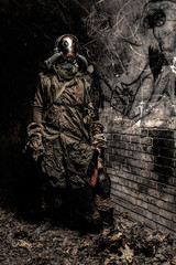 Survived in nuclear disaster or global ecological catastrophe human wearing rags, gas mask or air...