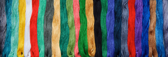 Threads of different colors and shades for embroidery and creativity.